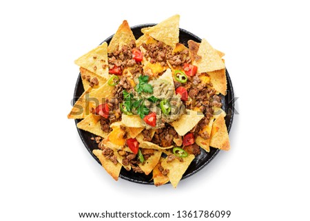 Corn chips nachos with fried minced meat and guacamole isolated on white background.
