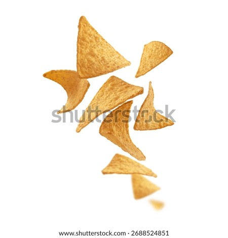 Corn chips of triangular shape levitate on a white background