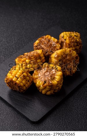Corn chunks grilled or barbecued with salt and spices. Grilled corn as a food background for your design.