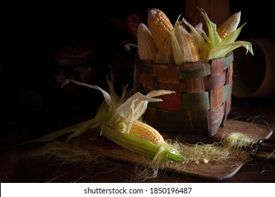 Corn Cobs In Basket And On The Wooden Table In Vintage Farm Moody Kitchen