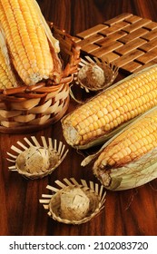Corn cobs. Closeup a corn cobs and corn cobs in wicker basket with straw hat miniatures
