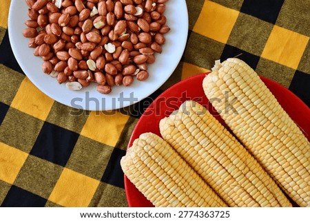 Corn cobs and roasted peanuts. Concept of traditional Brazilian June Festival (Sao Joao) food. Festa Junina. 