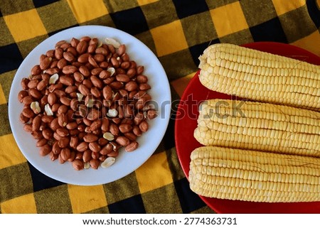Corn cobs and roasted peanuts. Concept of traditional Brazilian June Festival (Sao Joao) food. Festa Junina. 
