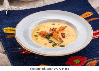 Corn Cream Soup With Shrimp And Bacon On The Table Side View