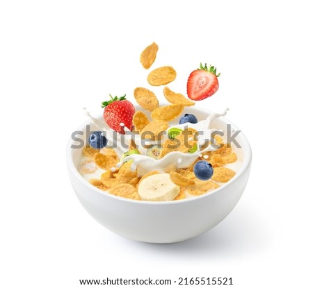Corn flakes with fresh milk splash and fruits isolated on white background.