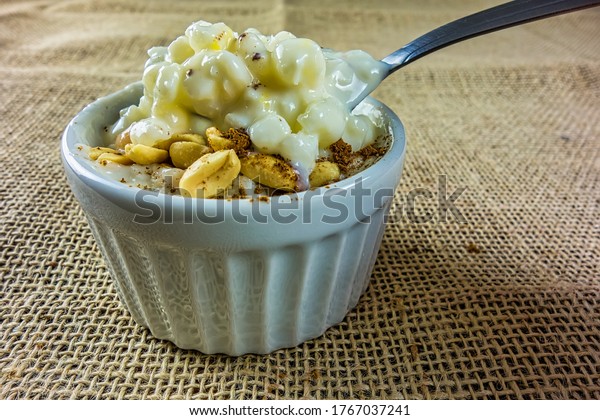 corn\
hominy with peanuts and cinnamon. Typical Brazilian dessert, aka\
Canjica, made with corn hominy, milk, coconut milk, condensed milk,\
sour cream, powdered milk, peanuts and\
cinnamon.