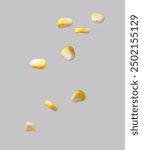 The corn kernels are flying against a gray background