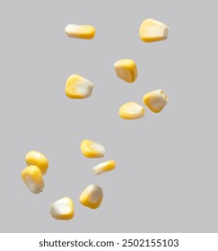 The corn kernels are flying against a gray background