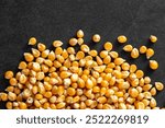 Corn kernels on black stone texture background