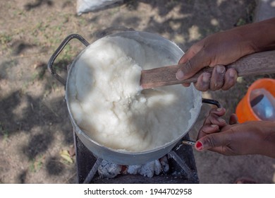 Corn Or Maize Flour Pap, A Staple Food In Many Countries In Africa Being Prepared In A Pot On Top Of A Coal Stove