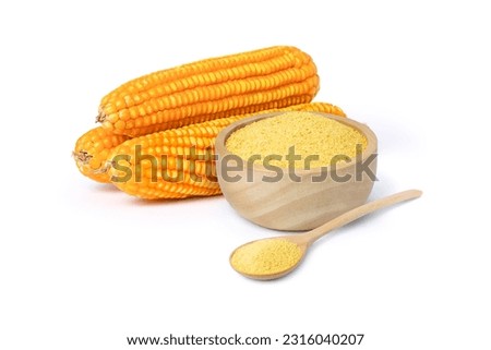 Corn meal polenta in wooden bowl and dry corn cobs isolated on white background.