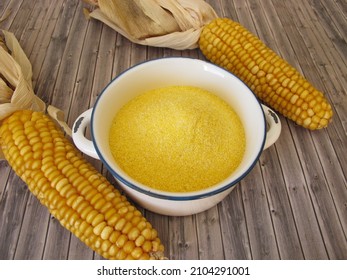 Corn semolina in a pot and maize ears