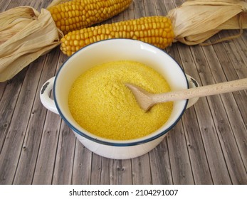 Corn semolina in a pot and maize ears