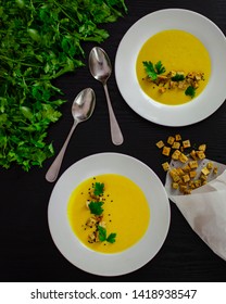 Corn Soup In A White Plate On A Black Background With Dill And Crackers