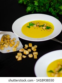 Corn Soup In A White Plate On A Black Background With Dill And Crackers