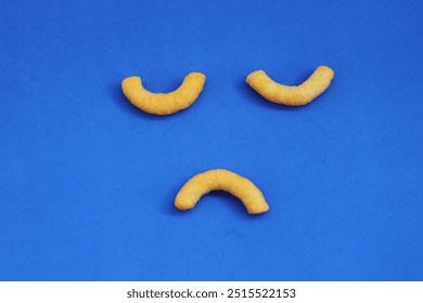 corn sticks, snack, smiley face, blue background, fun food, playful snack, food art, corn puffs, creative snack, happy face, food design, minimalistic, kids snack, bright background, cheerful, fun wit - Powered by Shutterstock