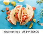 Corn taco shell with watermelon and feta salad, sprinkled lime