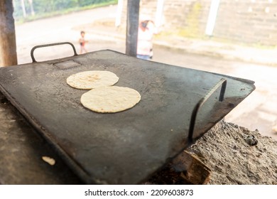 Corn Tortillas On A Metal Griddle. Latin American Cuisine