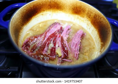 Corned Beef Brisket Cooked In A Dutch Oven, Pulled Apart With A Fork.