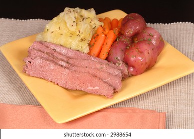 A Corned Beef And Cabbage Dinner With Potatoes And Carrots