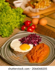 Corned Beef Hash Meal With A Crispy Fried Egg And Pickled Red Cabbage