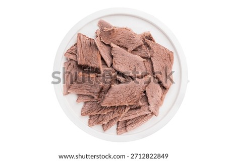 Corned Boiled and sliced beef meat with spices and herbs on a plate isolated on white background.