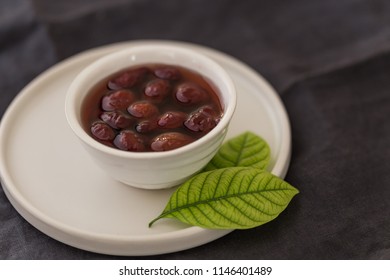 Cornelian cherry jam in white plate on black tablecloth