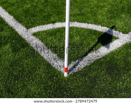 Corner arc and flag shadow on football pitch