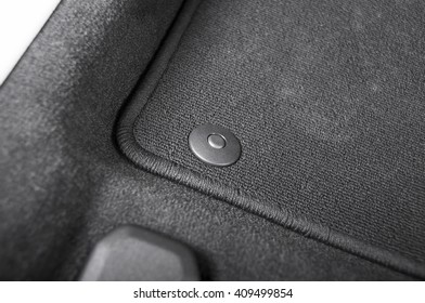 Corner Of  Black Car Mat With Floor Holder In  Car Interior