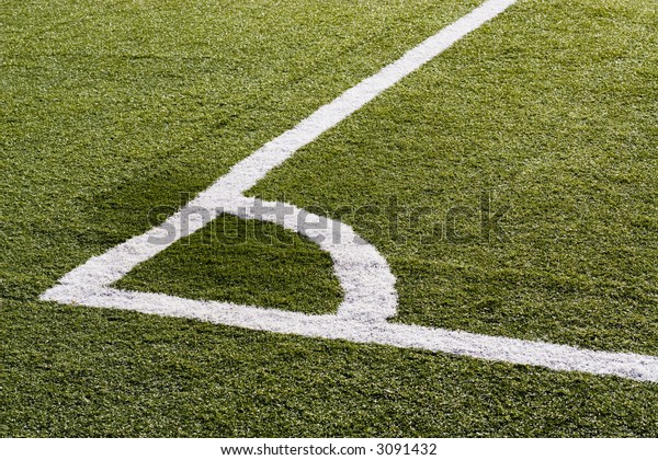 The corner\
boundary line of a soccer\
field.