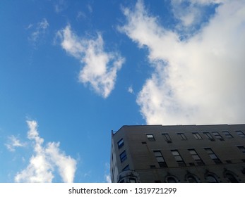 Corner of building with cloudscape
