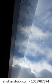 corner building with symmetrically reflected clouds