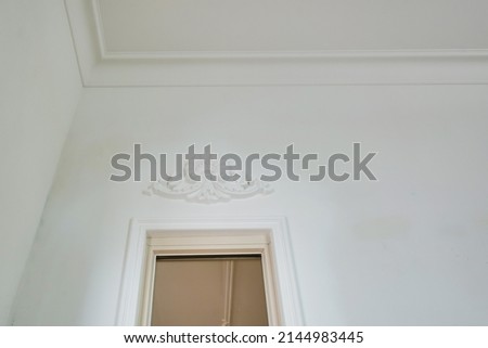 corner of ceiling cornice with intricate crown molding. 