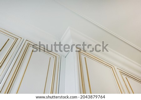 corner of ceiling and walls with intricate crown moulding. Interior construction and renovation concept.
