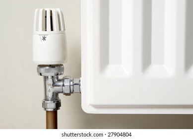 corner of a heating system radiator showing the temperature valve