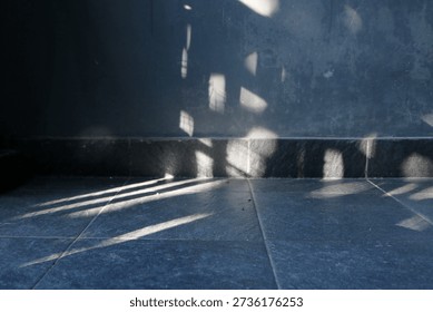 Corner with light spots on a dark wall create soft shadow, abstract light patterns add texture and mood, suggesting calm solitude.