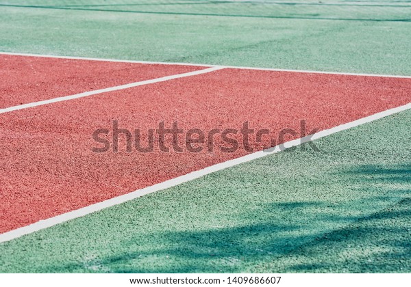 Corner markings on\
red tennis court for\
game