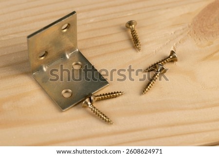corner and metal screws for construction work, a set of metal products for construction and fastening work, closeup
