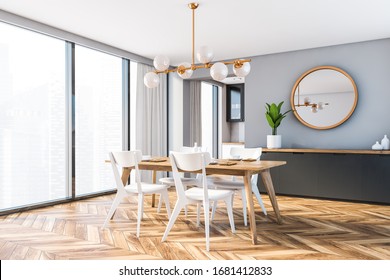 Corner Of Minimalistic Dining Room With Grey Walls, Wooden Floor, Dining Table With White Chairs And Round Mirror Hanging Above Grey Cabinet. 3d Rendering