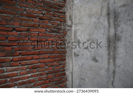 the corner section of the newly built brick wall, one side has been plastered with rough cement, and the other side has not yet been plastered with cement