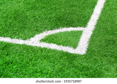 The corner of a soccer field close up. Corner in football. Corner markings on the football field. Green grass on the soccer field.