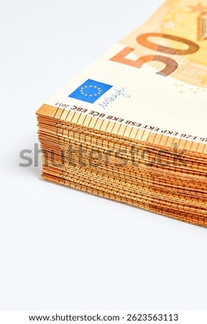 Corner of stack of 50 euro 2017 banknotes over white background close up with copy space