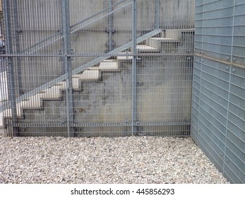 a corner with stairs and grey fence - Powered by Shutterstock