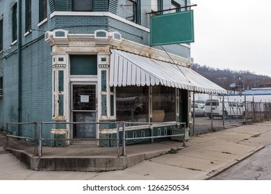 Corner Store In Old Fashioned Building With Decorative Door Frame On Overcast Day