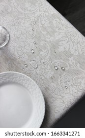 
corner of a table with two white plates