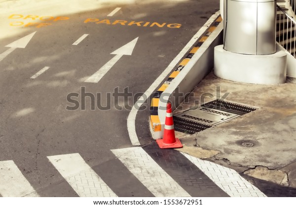 The corner of urban road turn\
right to parking lot with zebra crossing pedestrian for road\
safety.