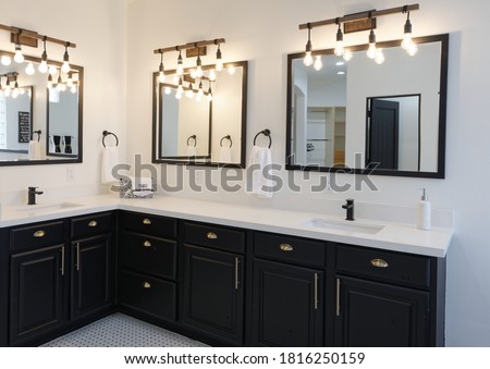 Corner vanity of modern style master bathroom with three mirrors
