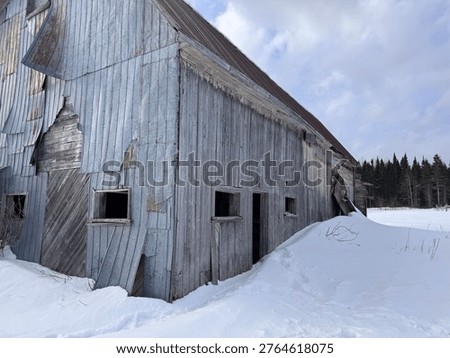 Corner view of barn abandoned in winter