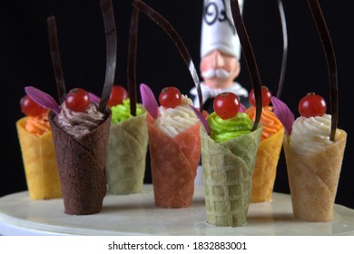 cornet dessert presentation with chef statue