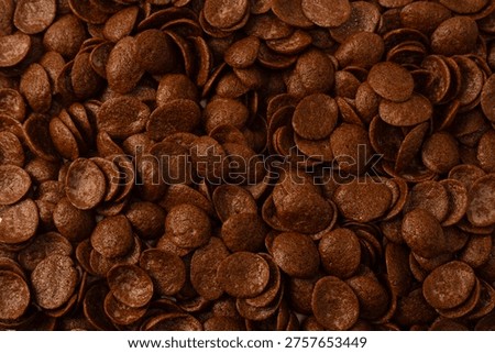 Corn-flakes background and texture. Chocolate cereal. Top view. 